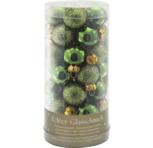 Véritable décoration en verre dans les tons verts dans un emballage transparent.