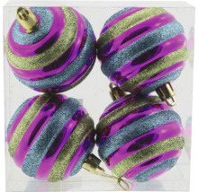 Quatre boules de Noël à rayures dans un récipient transparent