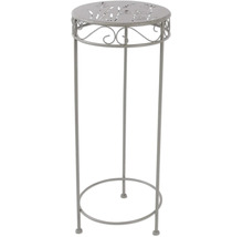 Dekosäule aus Metall mit Pflanzenmuster auf der Tischplatte