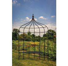 Tonnelle de jardin avec banc devant une prairie fleurie