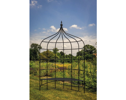 Tonnelle de jardin avec banc devant une prairie fleurie