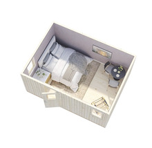 Vue intérieure d'une cabane de jardin avec lit, table et chaises