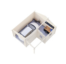 Garage avec zone d'atelier, comprenant voiture, vélo et établi