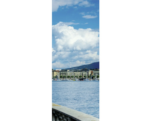 Vue sur un lac avec des bâtiments et des montagnes en arrière-plan