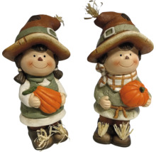 Deux figurines d'épouvantail avec des citrouilles pour la décoration d'automne