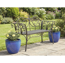 Banc de jardin en métal orné avec pots de fleurs sur une terrasse de jardin