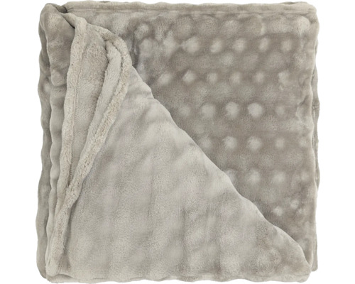 Couverture douce pliée avec structure à picots en polyester.