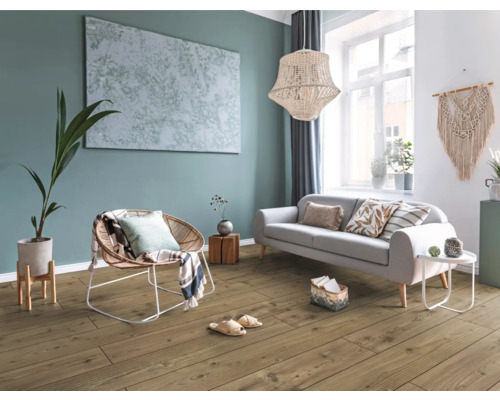 Modernes Wohnzimmer mit Bodenbelag in Holzoptik, Sofa, Rattan-Sessel und großformatigem Wandbild an einer Akzentwand.