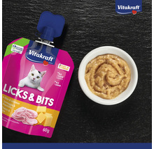 Snack pour chat Vitakraft Licks et Bits au fromage et au jambon, sachet de 60 grammes sans sucre ajouté ni céréales, et bol avec snack crémeux.