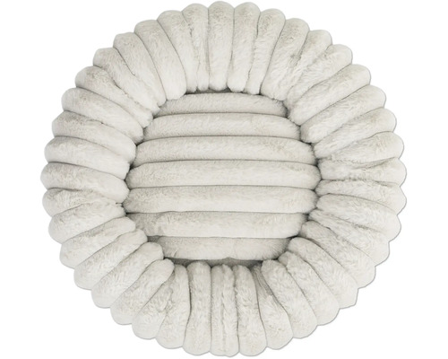 Coussin rond de couleur crème en peluche nervurée en fausse fourrure douce.