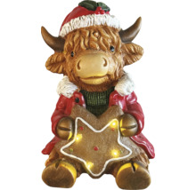 Figurine de Noël vache Highland avec bonnet de Noël et étoile lumineuse.