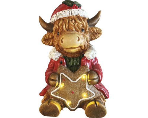 Figurine de Noël vache Highland avec bonnet de Noël et étoile lumineuse.