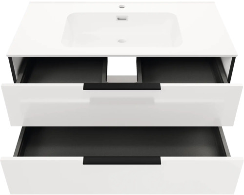 Weißer Waschtischunterschrank mit integriertem Waschbecken und zwei geöffneten Schubladen mit schwarzen Griffen und dunklem Innenleben.