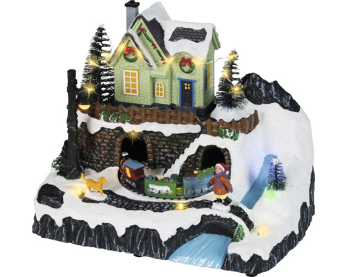 Village de Noël animé avec montagne enneigée, maison illuminée, train en mouvement, figurines et éclairage LED.
