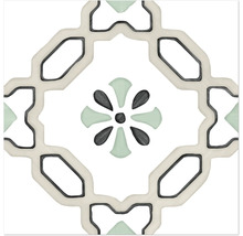 Carreau carré en grès cérame avec motif géométrique et motif floral central en vert et gris.