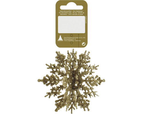 Goldene glitzernde Schneeflocke als Weihnachtsbaumschmuck an einer Kartonaufhängung.