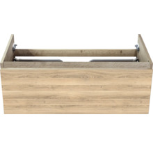 Meuble sous-vasque aspect chêne avec veinure de bois apparente et une façade de tiroir.