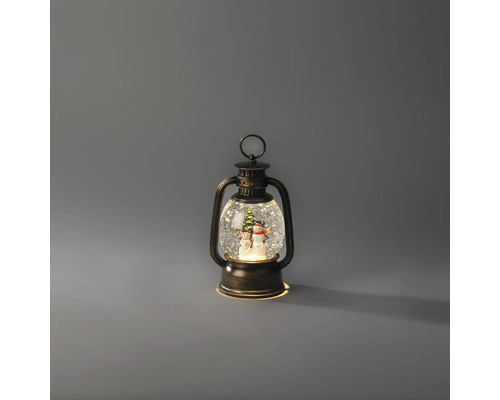 Beleuchtete dekorative Laterne in Bronze-Optik mit Schneekugel-Effekt, Schneemann und Weihnachtsbaum im Inneren.