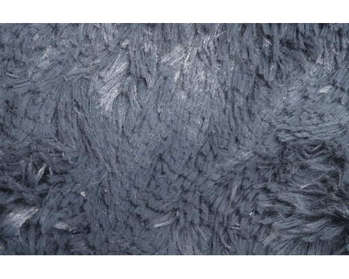Nahaufnahme der Textur eines Hochflor-Teppichs mit zotteliger Oberfläche.