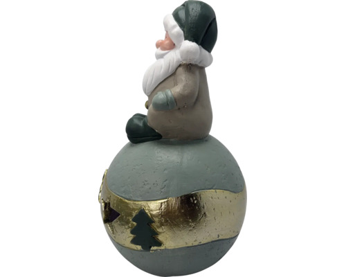 Figurine de Père Noël sur une boule avec bande dorée et découpe de sapin, en céramique.
