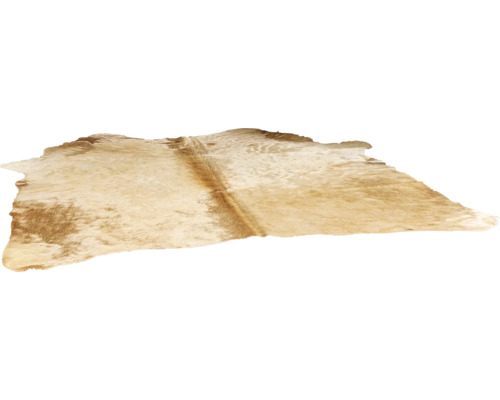 Tapis en peau de vache naturelle de forme irrégulière.