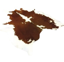 Tapis en peau de vache naturelle avec motif tacheté brun et blanc.