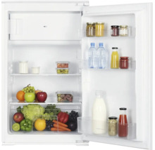 Offener Einbaukühlschrank mit Gefrierfach, gefüllt mit frischem Obst, Gemüse, Getränken und Gläsern, ordentlich sortiert auf Glasablagen.