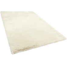 Rechteckiger, cremefarbener Hochflor-Teppich mit weicher, plüschiger Textur.