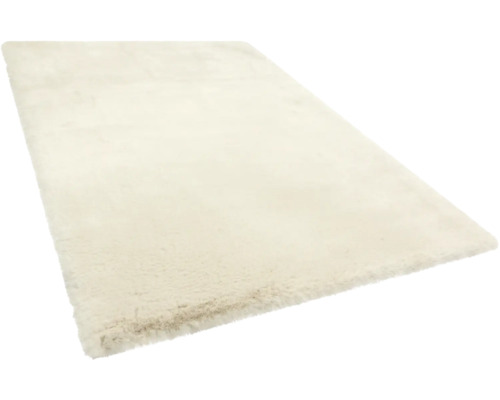 Rechteckiger, cremefarbener Hochflor-Teppich mit weicher, plüschiger Textur.