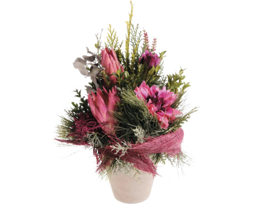 Bouquet de fleurs artificielles avec des protéas et des plantes vertes dans un pot de fleurs pour la décoration.