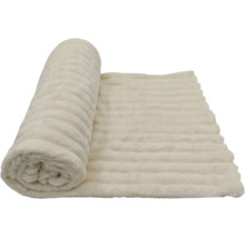 Eine weiche Wohndecke mit gerippter Struktur, teilweise zusammengerollt.