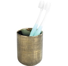 Zahnbürsten in einem goldenen Zahnputzbecher