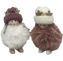 Zwei dekorative Weihnachtsfiguren mit Mütze und Fell