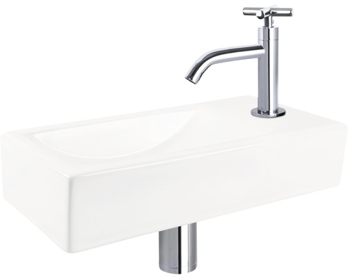 Lavabo en céramique avec robinetterie pour la salle de bains.