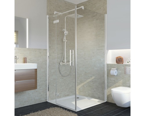 Cabine de douche avec robinetterie de douche, lavabo et toilettes dans une salle de bains