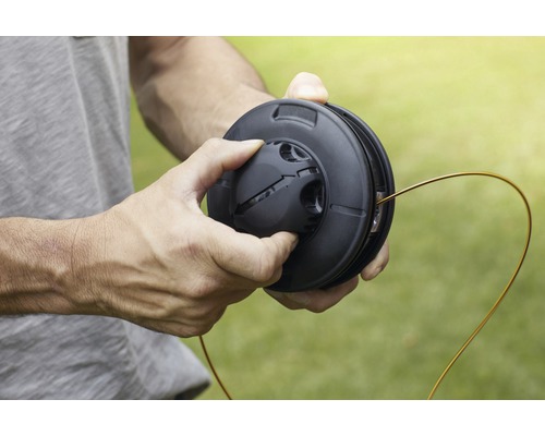 Mann hält Spule mit Trimmerfaden