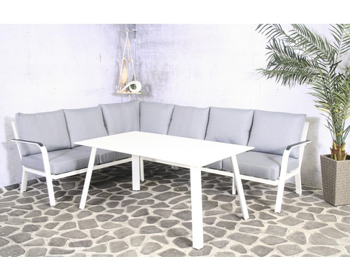 Ensemble de salon de jardin avec table et canapé d''angle sur terrasse en pierre
