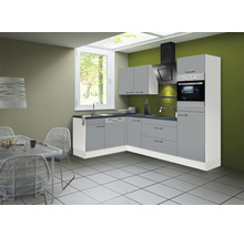 Cuisine moderne avec armoires grises, hotte aspirante et four.