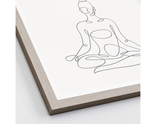 Gerahmtes Bild mit einer Strichzeichnung einer sitzenden Person in einer Meditationspose.