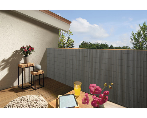 Balkon mit Sichtschutzwand, Holzhockern und Dekoration