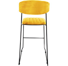 Tabouret de bar avec assise et dossier en velours et un cadre en métal.