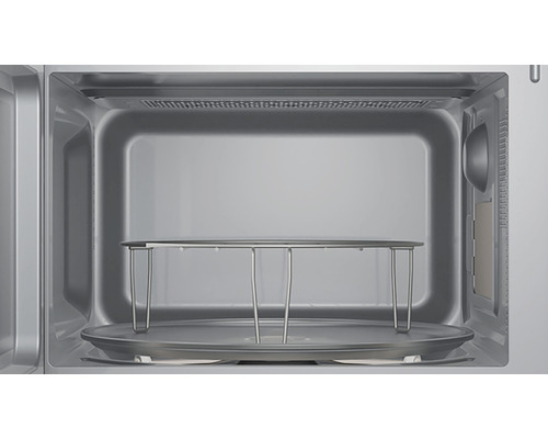 Intérieur d''un four à micro-ondes avec plateau tournant et grille