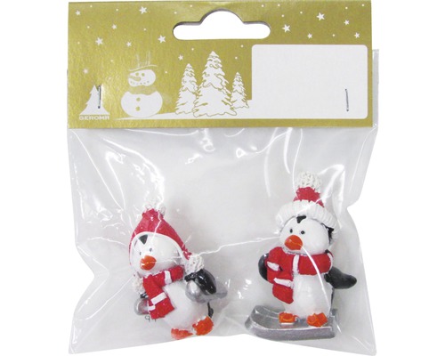 Zwei Pinguinfiguren mit Mütze und Schal als Weihnachtsdekoration in Verpackung
