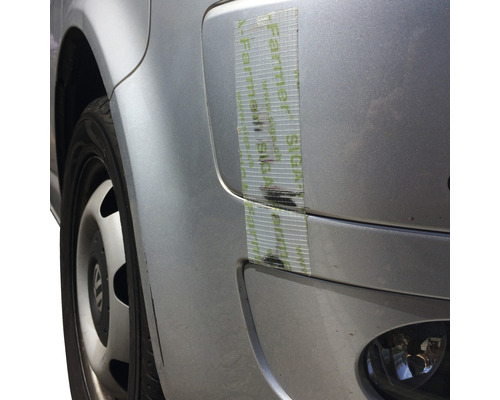 Gros plan d''une voiture avec du ruban adhésif de réparation sur la carrosserie