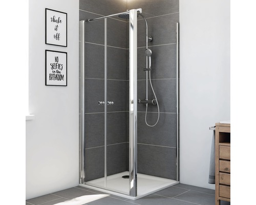 Douche d''angle avec deux portes tournantes en verre et robinetterie dans la salle de bain