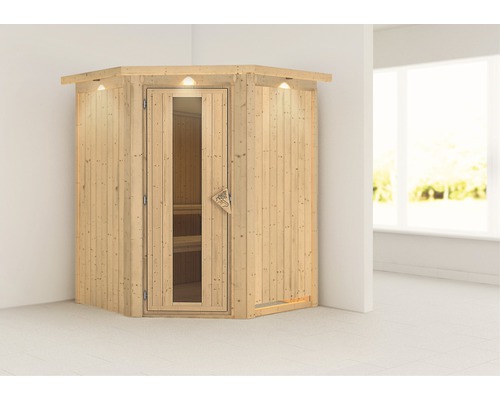 Sauna d''angle avec porte en verre et éclairage intérieur dans une pièce lumineuse