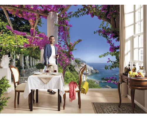 Papier peint photo avec homme sur une terrasse avec vue sur la mer