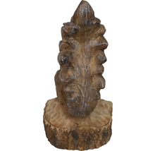 Holzfigur in Form eines Tannenzapfens auf einem Sockel
