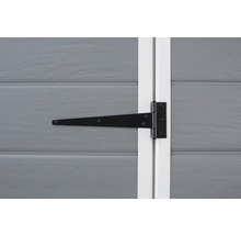 Charnière en T noire sur une porte en bois grise