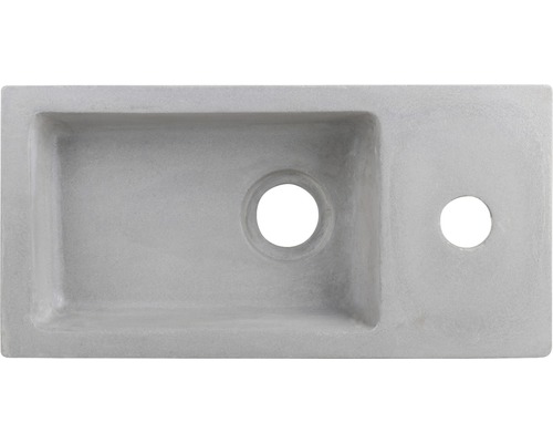 Aufsicht auf ein Waschbecken aus Beton mit Hahnloch